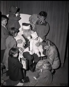Macy And Company Prints: Mother and Children Huddled Around Santa