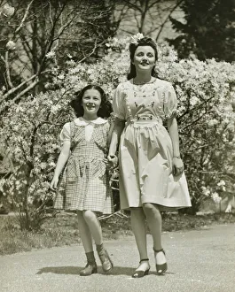 35 39 Years Collection: Mother and daughter (8-9) strolling in park, (B&W)