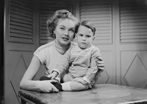 Mother embracing son (2-3) indoors, portrait