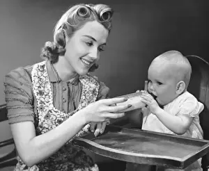 Mother holding bottle for baby