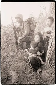 Mother Holding Child as Soldiers Pass