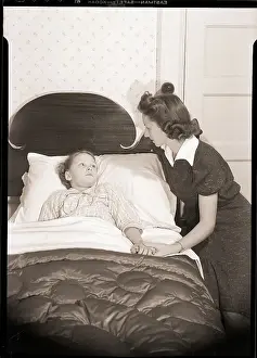 Mother Holding Child's Hand in Bed
