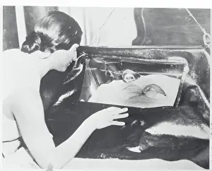 Mother Observing Child in Oxygen Tent