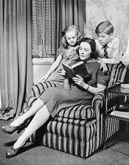 Mother reading to daughter & son