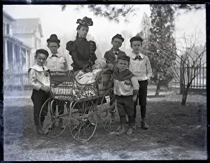 Mother, Sons Stand Around Baby Carriage