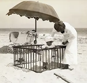 Mother with Toddler in Playpen on Beach