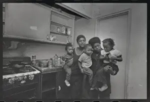 Mothers Holding Children by Stove for Warmth