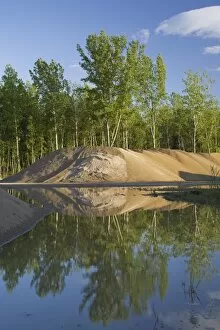 Mounds of sand in a commercial sandpit after a heavy rainfall, Quebec, Canada