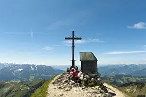 Summit Cross Prints: Mountain climber at the summit cross with a small chapel on Geigelstein Mountain