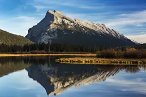 Mountain lake reflecting mountain at sunset with blue sky and clouds, Banff National Park