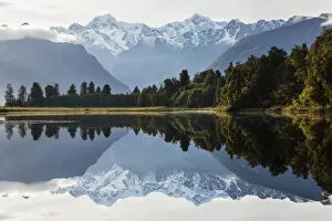 Rain Forest Gallery: Mountains and forest reflecting in still lake, Fox Glacier, South Westland, New Zealand