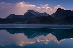 Mountains reflected in still rural lake