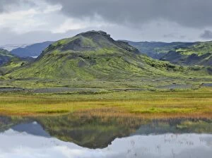 Mountains reflected in a small lake near Soelheimajoekulsvegur, Iceland