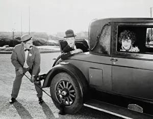 Tire Prints: Movie Still;Changing Tire, Using Jack