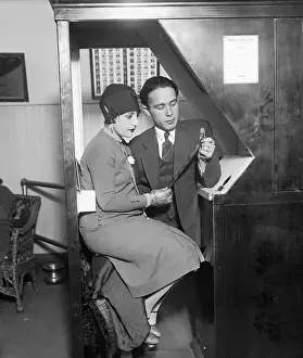 Mr. and Mrs. Anatol Josepho Looking at Photo Strip
