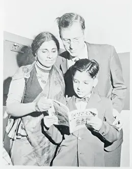 Mr. and Mrs. Harvey Renfrew Reading With Their Son