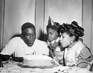 Mr. and Mrs. Jackie Robinson and Son Blow Birthday Cake Candles