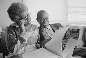 Mr. and Mrs. Louis Armstrong Gazing at Scrapbook at Home