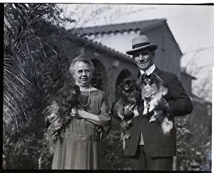 Retiree Prints: Mr. and Mrs. Tommy Ryan Hold Dogs Before Home
