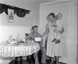 12 23 Months Prints: Mrs. Gus Axelson Serving a Meal to Her Husband