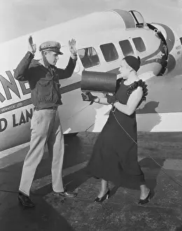 Mrs. Harry Downes Pointing Light Beam at Husband