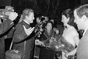 Mrs. Kennedy with Photographers Holding Carnations