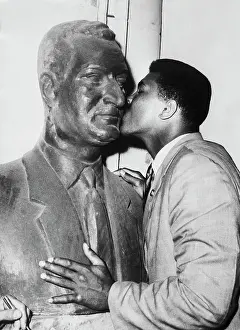 Prints of (Original Caption) 6/4/1964-Cairo, U.A.R.- World heavyweight champion Cassius Clay kisses a bust of United Arab Republic President Gamal Abdel Nasser A photo tribute to the boxing legend: Muhammad Ali Kissing Abdel Nasser Statue