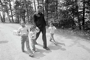 Muhammad Ali Walking with Twin Daughters
