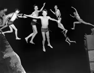 Strange Prints: Multiple image of pre--teen boy jumping into water