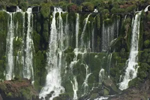 Multiple waterfalls along a fault line in tropical vegetation