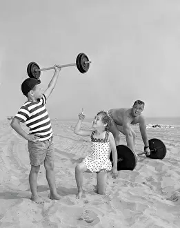 Americana Prints: Muscleman and muscleboy on the beach in California, ca. 1958