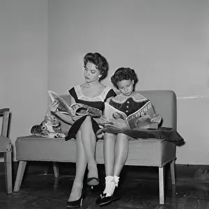 Prints of American actress Natalie Wood (1938 - 1981) and her sister Lana Wood reading magazines in the dressing room of a clothes shop, US, 4th January 1956 Grace, Glamour & Timeless Elegance: Natalie and Lana Wood