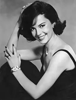 Prints of circa 1960: American actor Natalie Wood, wearing a black evening dress, smiles while posing in a promotional portrait for director Michael Anderson's film, All the Fine Young Cannibals' Grace, Glamour & Timeless Elegance: Natalie Wood