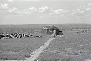 Hogan Prints: Navajo Woman Walking Towards Hogan