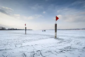 Frost Collection: Navigation mark on a frozen Lake Constance with skaters, island auf Reichenau, Konstanz district