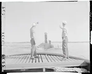 Navy Men Atop Submarine