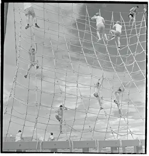 Navy Men Climbing Large Rope Obstacle