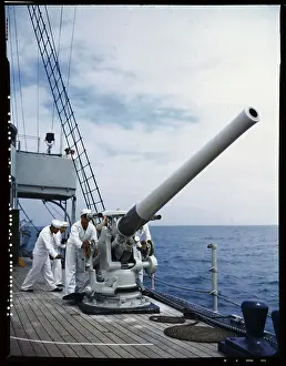 Navy Men Training with Gun on Ship