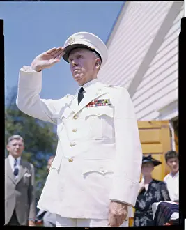 George C Prints: Navy Officer Saluting at Military Event