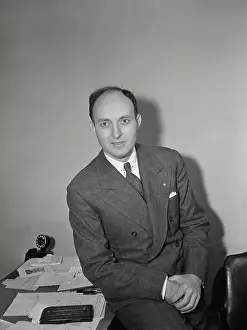 Prints of (Photo by Bettmann Archive/Getty Images) Hoops Through Time: A Visual Journey of Basketball History: Ned Irish Basketball Promoter Sitting on Desk