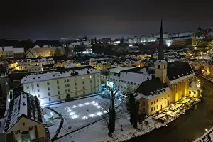 Neumunster Abbey in Luxembourg at night under snow