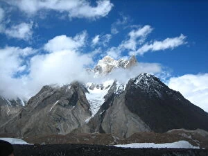New Cristal Peak and Marble Peak in clouds from Concordia camp site in Karakorum range