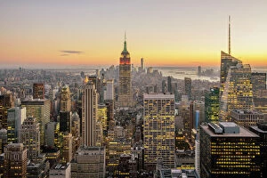 Aerial View Collection: New York City skyline with illuminated skyscrapers seen from above during sunrise, New York State