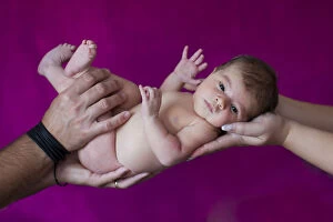 Newborn baby, five days, carried on hands