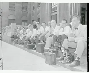 News Photographers Resting on Sidewalk