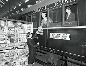 Express Prints: News Vendor Handing Magazine to Simplon-Orient Express Passenger