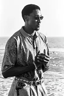 Prints of Scottie Pippen of the Chicago Bulls is interviewed wearing sunglasses, a collared print shirt, jeans, and embellished belt Timeless Moments: A Visual Journey Through History’s Defining Images: Nike Commercial