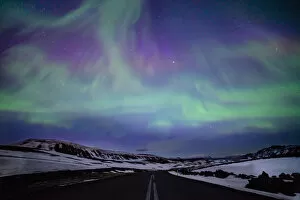Finland Collection: Northern lights over distant mountains in Iceland
