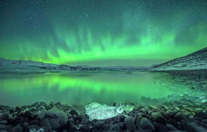 Cold Temperature Collection: Northern lights with reflection at Jokulsarlon