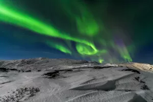 Images Dated 16th February 2016: Northern lights over the snow-capped mountains